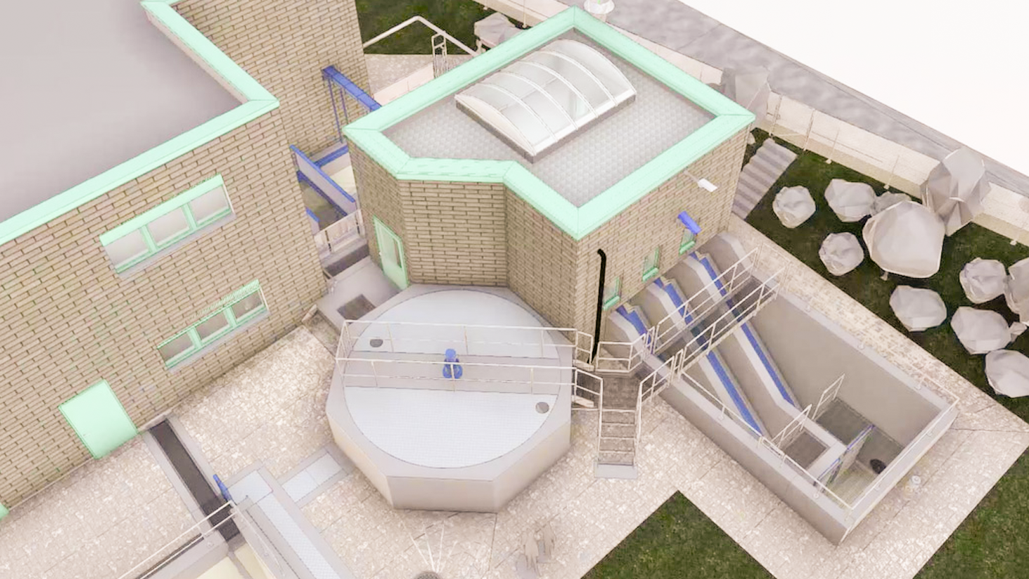 Luftaufnahme einer modernen Kl&auml;ranlage mit grauen Geb&auml;uden, Metallgel&auml;ndern, Tanks und einem felsigen Gel&auml;nde in der N&auml;he.